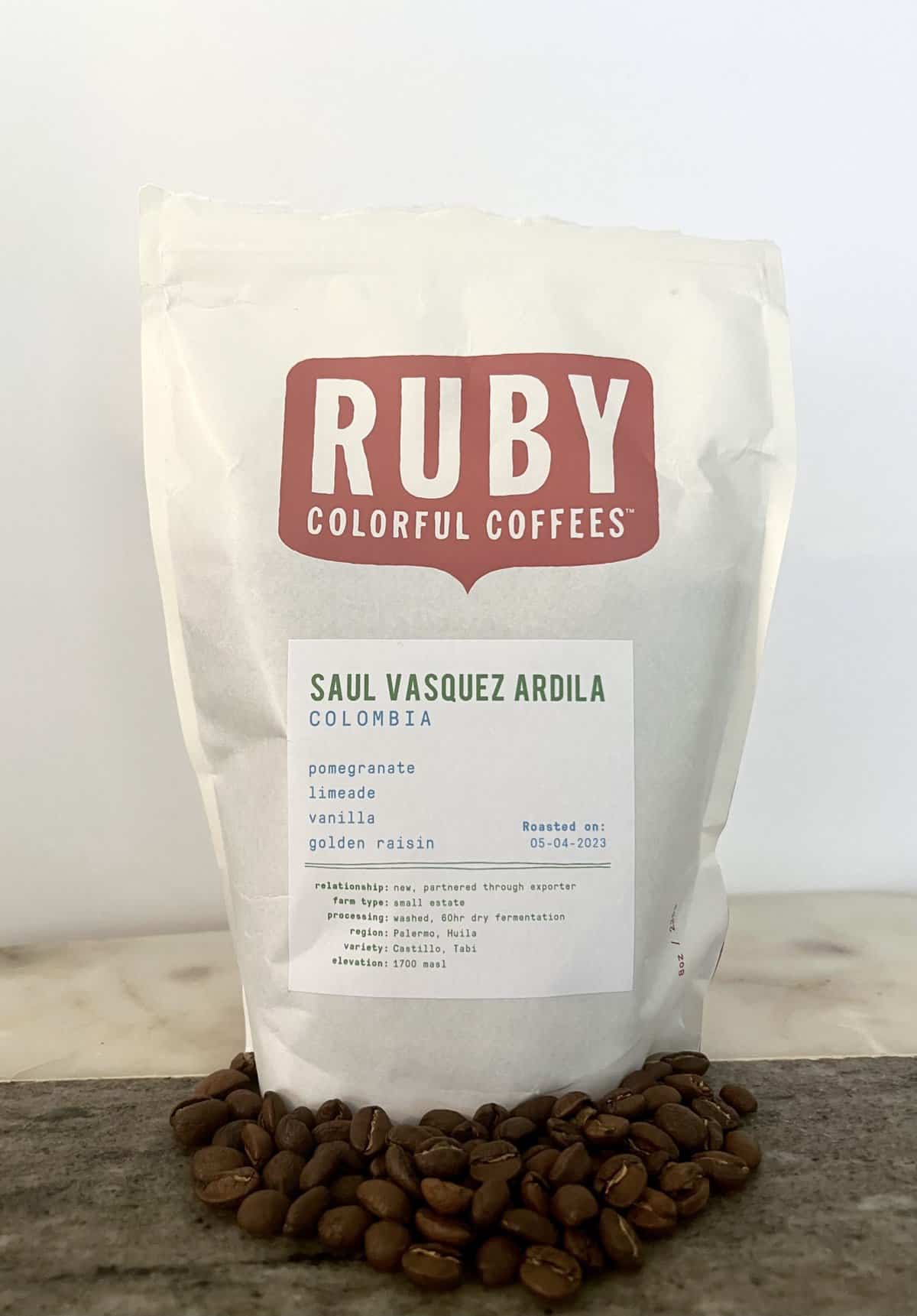 Ruby-Coffee-stands-on-coffee-beans-scaled