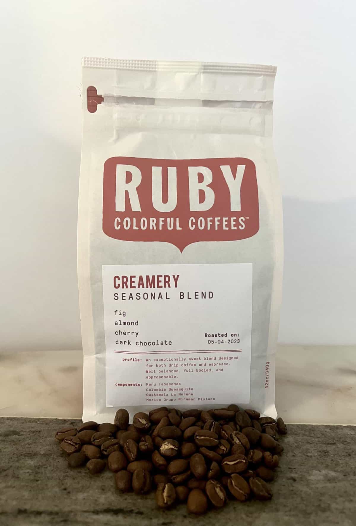 Creamery-Seasonal-Blend-coffee-stands-on-coffee-beans-scaled